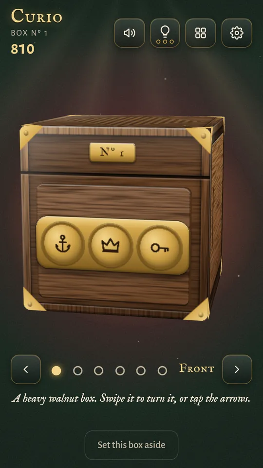 Box 1, a walnut cube at rest with three brass dials on its front face, and arrows and dots below it for turning the box
