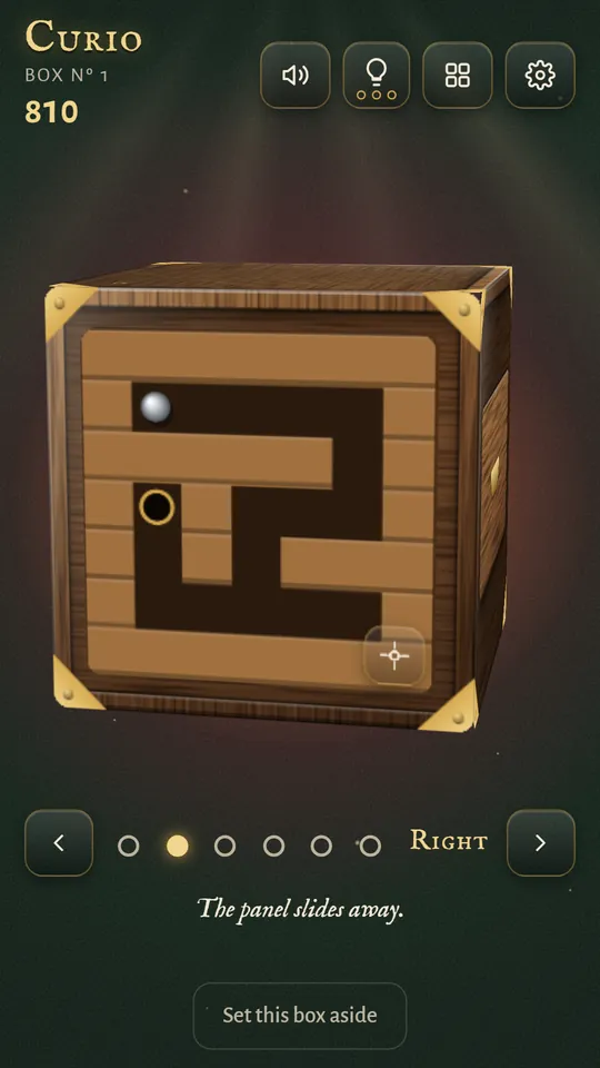 A tilt maze carved into a wooden face, with a steel ball to roll to the hole and keep out of the pits