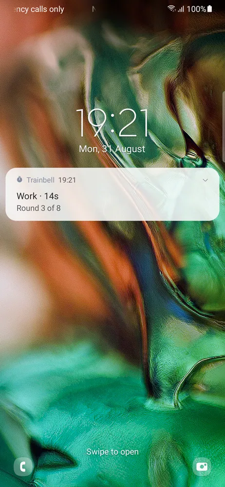 The lock screen with a Trainbell notification that keeps counting the workout while the screen is off: Work, 14 seconds, round 3 of 8